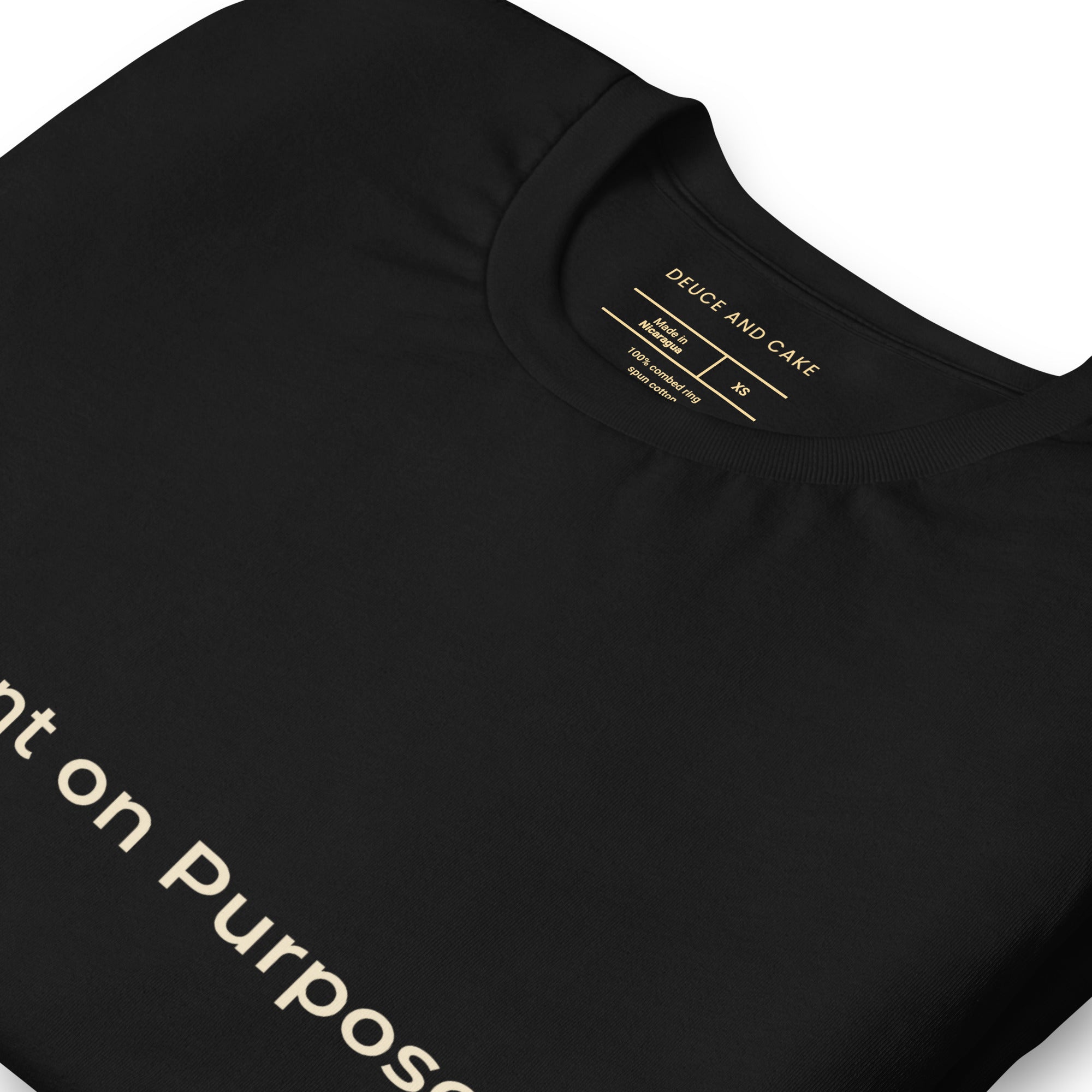 Black unisex t-shirt with the words, Different on Purpose in light gold lettering. 
