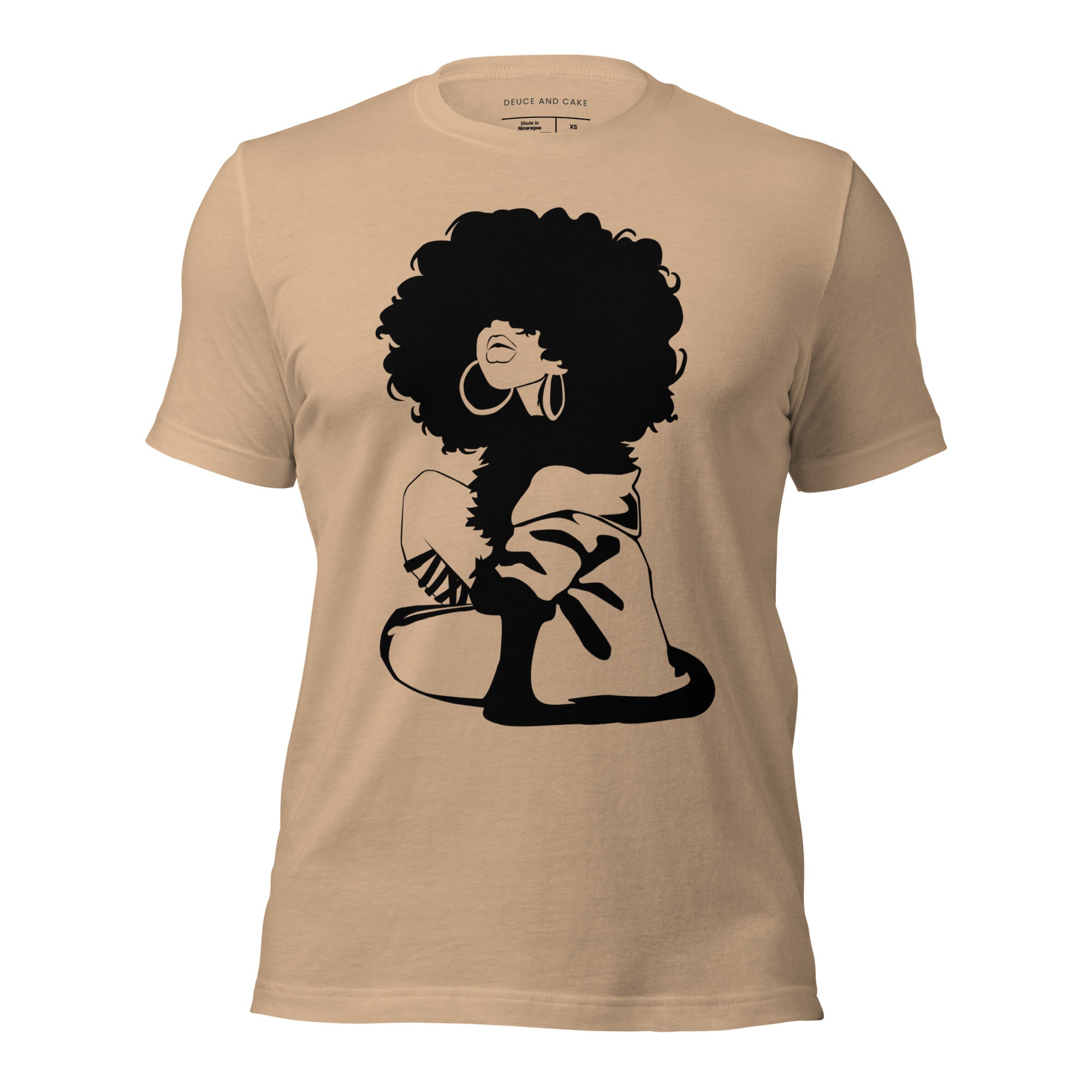 Tan t-shirt with a graphic of woman with afro and wearing a sweater.