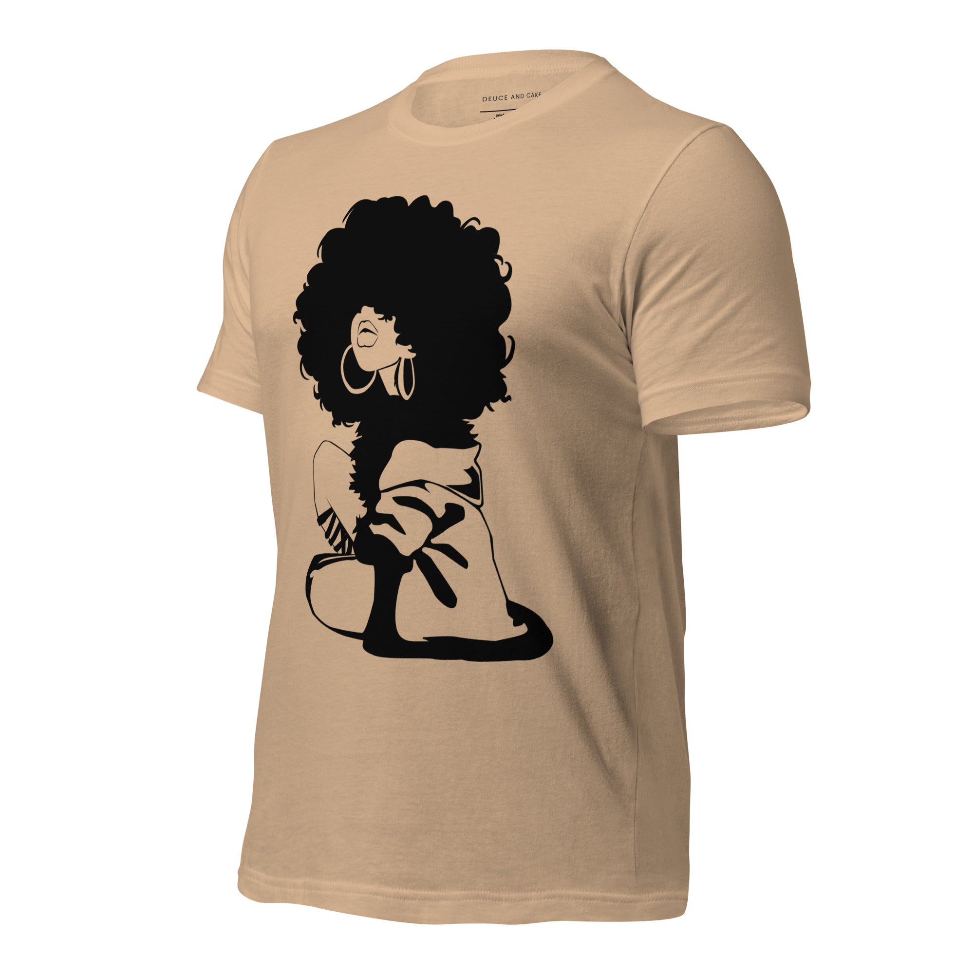 Tan t-shirt with a graphic of woman with afro and wearing a sweater.