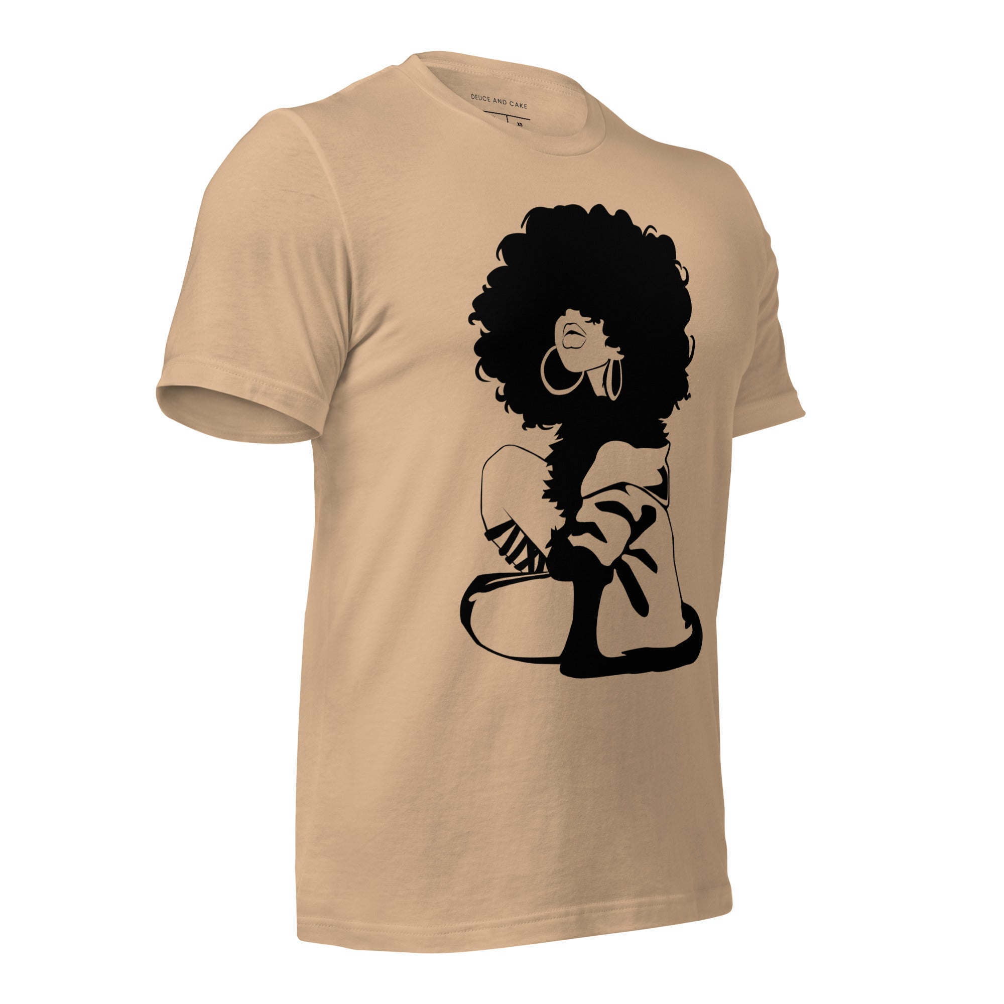 Tan t-shirt with a graphic of woman with afro and wearing a sweater.